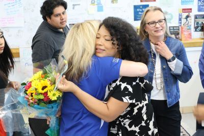 Janet Damon gets a hug after learning she is a Teacher of the Year finalist.