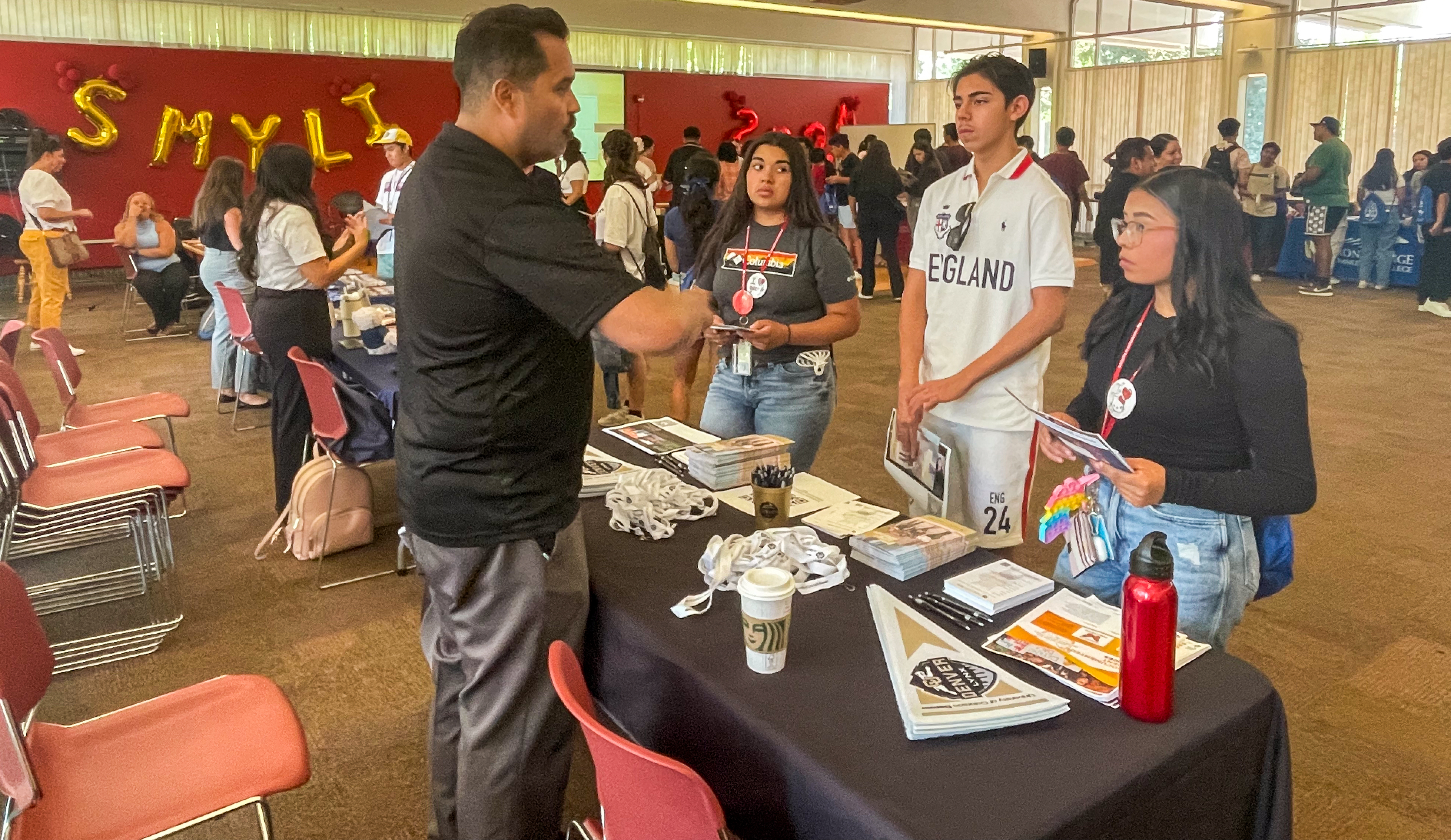 Migrant students gather around presentators offering secondary student pathways