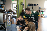 Colorado teacher talking to kids at a computer.