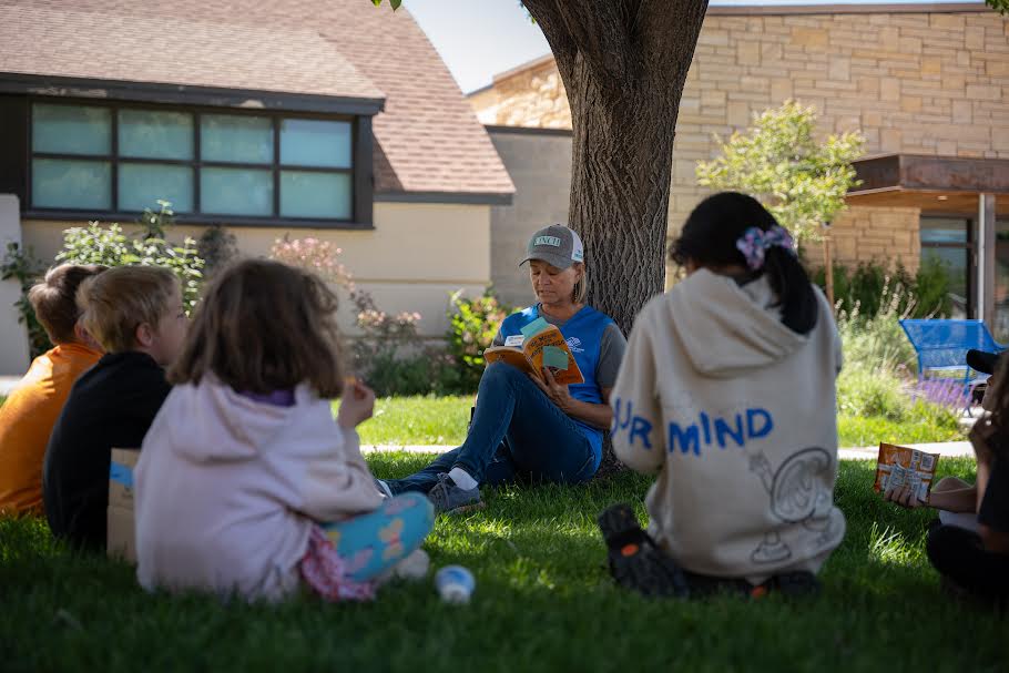 Teacher reads at the Mancos summer camp that was made possible with ESSER III funds.