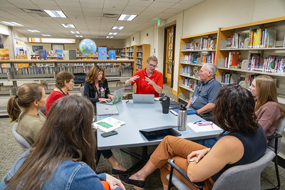 Table of educators meeting in a school library