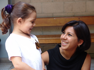 Smiling teacher with young student